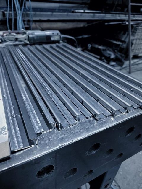 Long formed strips laid side by side on the fixture table