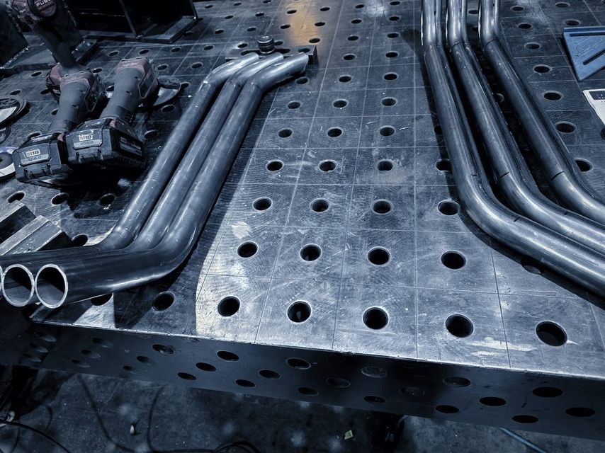 Bent tubes with coped ends on the fixture table