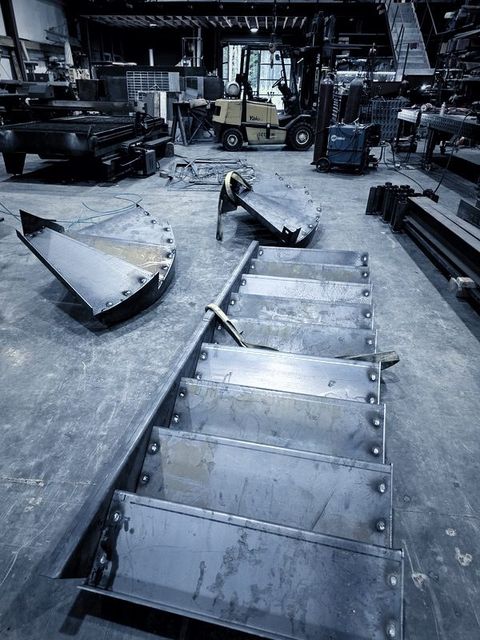 Stair treads fixed to a stringer lying on the shop floor